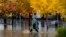 A pedestrian walks along a flooded street during a storm Nov. 21, 2024, in Santa Rosa, Calif.