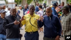 FILE — Then former African National Congress (ANC) treasurer general and now South African Deputy President Paul Mashatile, center, walks out following a meeting of the ANC's national executive committee, in Johannesburg, South Africa, Friday Dec. 2, 2022