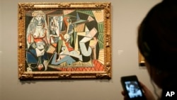 Visitor uses digital guide to "Women of Algiers (Version O)," 1955, by Pablo Picasso at The National Gallery, London, Feb. 24, 2009.