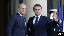 French President Emmanuel Macron welcomes Poland's Prime Minister Donald Tusk before an informal summit of European leaders to discuss the situation in Ukraine and European security at The Elysee Presidential Palace in Paris on Feb. 17, 2025.