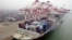 A cargo ship loaded with containers is seen anchored at a port in Qingdao, Shandong province, China, July 10, 2013.