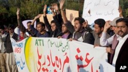 Pakistani students shout slogans against the Islamic State group holding a banner that reads "down with Islamic State rally," in Islamabad, Nov 20, 2014.