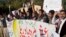 Pakistani students shout slogans against the Islamic State group holding a banner that reads "down with Islamic State rally," in Islamabad, Nov 20, 2014.