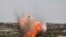An explosion is seen following Russian airstrikes on the village of al-Bara in the southern part of Syria&#39;s northwestern Idlib province.