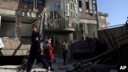 Afghans gather in front of the Shi'ite cultural center after a suicide attack in Kabul, Afghanistan, Dec. 28, 2017.