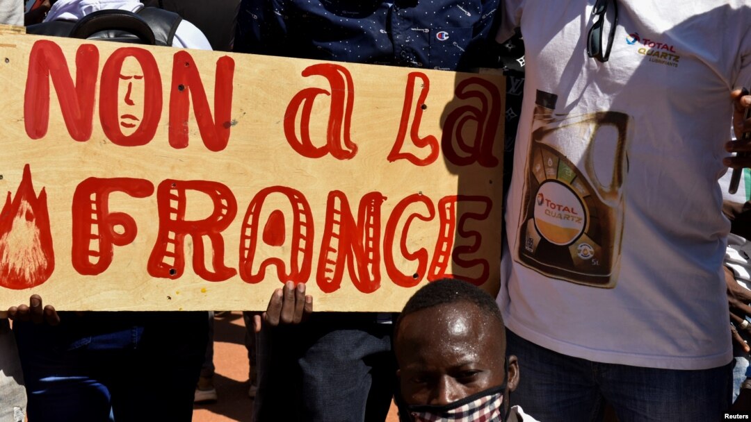 Demonstrators hold a placard that reads "No to France" during a protest calling for the departure of French forces from Burkina Faso, in the capital Ouagadougou, Nov. 16, 2021.