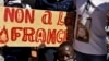 Demonstrators hold a placard that reads "No to France" during a protest calling for the departure of French forces from Burkina Faso, in the capital Ouagadougou, Nov. 16, 2021.