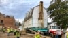 FILE - Workers prepare to move the original structure that held what is believed to be the oldest schoolhouse in the U.S. for Black children in Williamsburg, Virginia, Feb. 10, 2023.