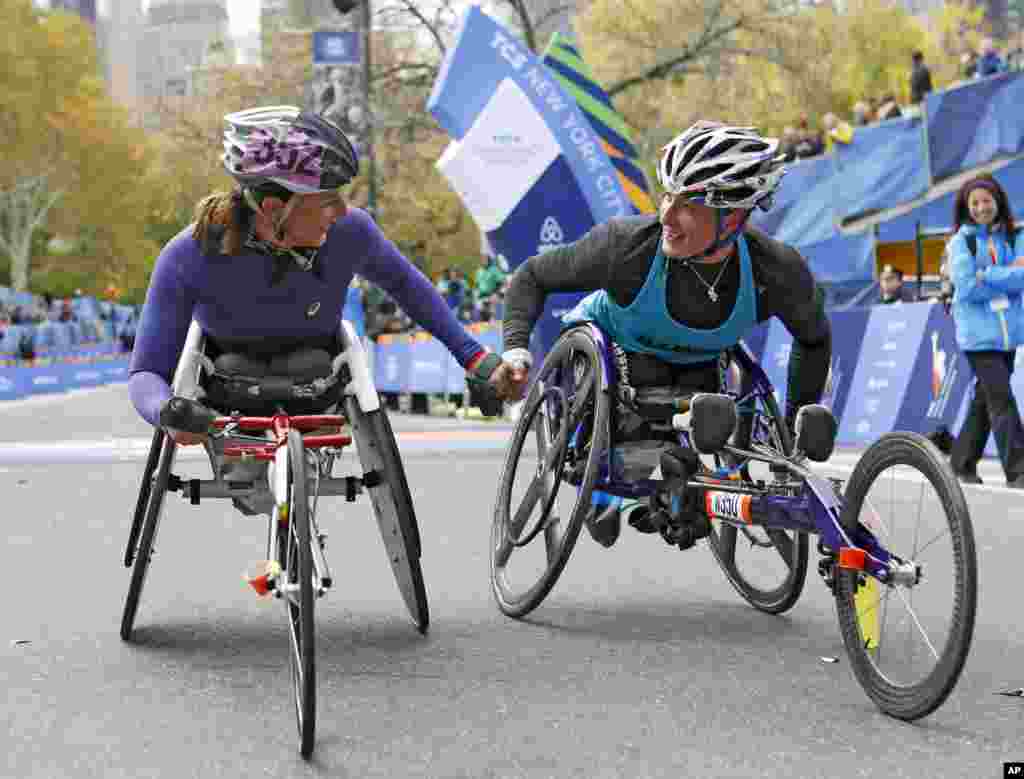 Runner-up Manuela Schar, left, of Switzerland, congratulates winner Tatyana McFadden of the United States after the pair competed in the women's wheelchair division of the 44th annual New York City Marathon in New York, Nov. 2, 2014. 