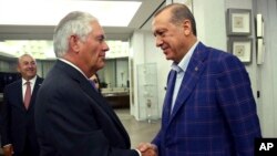 In this July 9, 2017, photo made available July 10, 2017, Turkey's President Recep Tayyip Erdogan, right, shakes hands with U.S. Secretary of State Rex Tillerson, left prior to their meeting in Istanbul. 