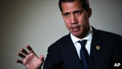 FILE - Leader of Venezuela's political opposition Juan Guaido talks to a journalist during an interview with The Associated Press in Brussels, Jan. 22, 2020. 