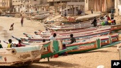 Children play on fishing boats known as pirogues in Dakar, Senegal, June 24, 2023. Large pirogues such as the one found Aug. 15, 2023, near Cape Verde are used in migrant crossings from Senegal to Spain.