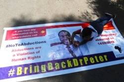 A Zimbabwean doctor lays on a banner during a protest in Harare, Sept, 18, 2019.