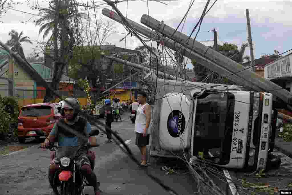 Residents are seen after Typhoon Kammuri hit Camalig town, Philippines.