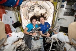 FILE - In this photo released by NASA on Oct. 17, 2019, U.S. astronauts Jessica Meir, left, and Christina Koch pose for a photo in the International Space Station. The two, along with Andrew Morgan, looked after the space mice.