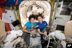 FILE - In this photo released by NASA on Oct. 17, 2019, U.S. astronauts Jessica Meir, left, and Christina Koch pose for a photo in the International Space Station. The two, along with Andrew Morgan, looked after the space mice.