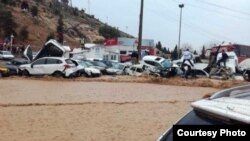 A flash flood hits the southern Iranian city of Shiraz, March 25, 2019, causing cars to pile up on a road near its historic Quran Gate.