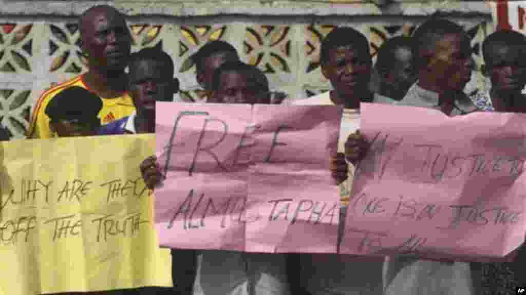 Supporters of Maj. Hamza Al-Mustapha carry placards in Lagos, Jan. 30, 2012.