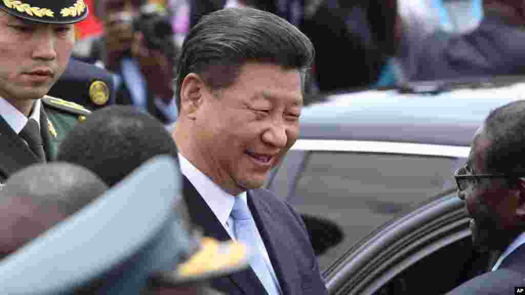 Chinese President Xi Jinping, chats to Zimbabwean President Robert Mugabe, right, upon his arrival in Harare, Zimbabwe, Tuesday, Dec. 1. 2015. Jinping is in Zimbabwe for a two day State visit during which he is set to sign some bilateral agreements aimed at strengthening relationships between the two countries. 