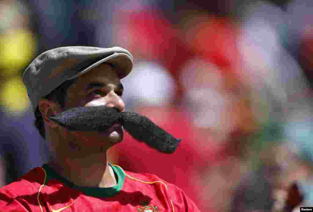 Um fã de Portugal usa um bigode postiço antes do jogo contra a Alemanha, para a fase de grupos do Mundial, na Arena Fonte Nova, Salvador&nbsp; Junho 16, 2014. REUTERS/Marcos Brindicci