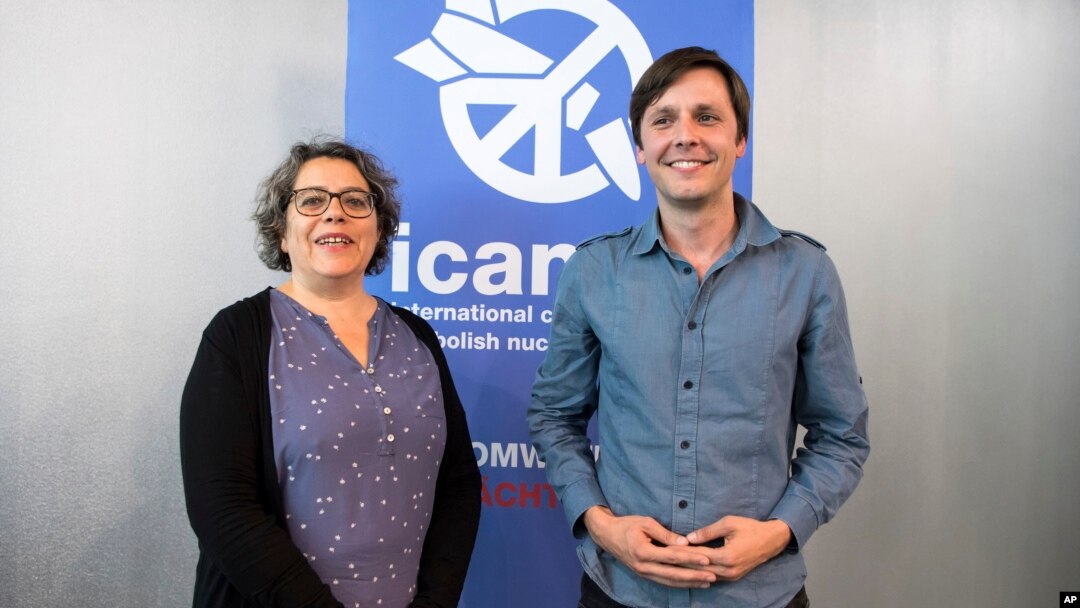 Sascha Hach, right, and Xanthe Hall of the International Campaign to Abolish Nuclear Weapons ICAN Germany, pose in their office in Berlin, Oct. 6, 2017.