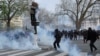 Polisi antihuru-hara di Paris menembakkan gas air mata ke arah pengunjuk rasa dalam aksi protes hari Selasa (28/3). 