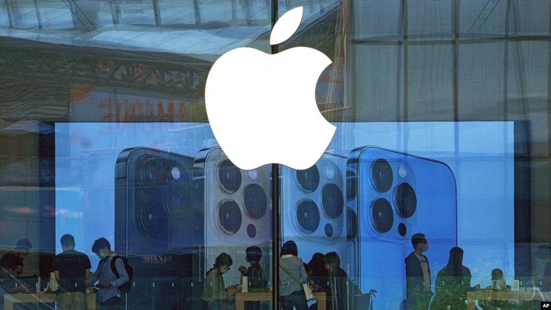 FILE - People try out iPhone products at an Apple Store in Beijing, Sept. 28, 2021. Apple's release this month of its iPhone 16, new Apple Watch, and AirPods, is creating a buzz.