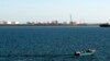 FILE - A speed boat passes by oil docks at the port of Kalantari in the city of Chabahar, 300km (186 miles) east of the Strait of Hormuz, Jan. 17, 2012. 