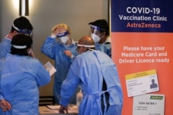 Medical staff work in the waiting area at a COVID-19 vaccination clinic at the Bankstown Sports Club as the city experiences an extended lockdown, in Sydney, Australia, Aug. 3, 2021.