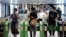 Passengers wearing protective face masks pass through the automated entranceway at a station amid the coronavirus disease (COVID-19) outbreak in Tokyo, Japan, July 23, 2020.  