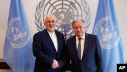 FILE - Iranian Foreign Minister Mohammad Javad Zarif, left, shakes hands with U.N. Secretary General Antonio Guterres at United Nations headquarters, July 18, 2019.