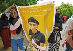 Sudanese protesters march in the capital Khartoum, on June 3, 2021, during a demonstration calling for justice for protesters killed during anti-government demonstrations two years ago.