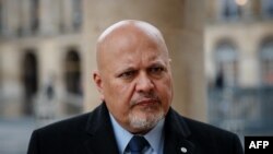 FILE - ICC Prosecutor Karim Khan poses during an interview with AFP at the Cour d'Honneur of the Palais Royal in Paris on February 7, 2024. He says environmental damage is often the cause or consequence of war crimes or crimes against humanity that the ICC can already judge.