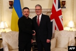 Britain's Prime Minister Keir Starmer shakes hands with Ukraine's President Volodymyr Zelenskyy during a meeting in London on March 1, 2025, ahead of a European leaders summit the following day.