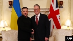 O primeiro-ministro britânico, Keir Starmer, cumprimenta o Presidente ucraniano, Volodymyr Zelenskyy, durante uma reunião em Londres, a 1 de março de 2025, antes da cimeira dos líderes europeus.