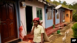 Tea plantation worker Adaraja Ali Rani leaves her living quarters to pluck tea tips in Spring Valley estate in Badulla, Sri Lanka, Sep. 10, 2024.