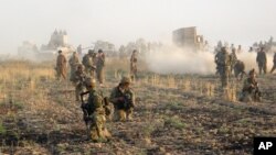 FILE - Kurdish Peshmerga troops deploy during a military operation to regain control of some villages from Islamic State group fighters south of oil-rich city of Kirkuk, 180 miles (290 kilometers) north of Baghdad, Iraq, Aug. 26, 2015.