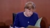 German Chancellor Angela Merkel reads documents after she arrives for the weekly cabinet meeting of the German government at the chancellery in Berlin, Germany, Jan. 8, 2020.