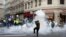 Demonstrators run away through tear gas in Lyon, central France, Dec. 15, 2018.