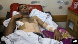 Marwan Shtewi, 32, lies in the surgery's ward of Shifa hospital in Gaza City, May 16, 2018. Shtewi was shot in his hand and abdomen by Israeli troops during a protest east of Gaza City on Monday. With few prospects and little to fear, Shtewi is among the young men who protest along the border with Israel, risking their lives in a weekly showdown meant to draw attention to the dire conditions of Gaza. 