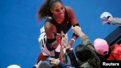 Serena Williams signs autographs after winning her Women's singles semi-final match against Croatia's Mirjana Lucic-Baroni. 