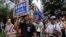 Protesters hold placards and wave Hong Kong colonial flags during the annual pro-democracy protest in Hong Kong. As the Asian financial center prepares for legislative elections in September, a new wave of radical political activists are planning to join the campaign, including some who advocate the once-unthinkable idea of independence from China, July 1, 2016.