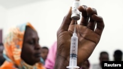 FILE - Staff members of the Teaching Hospital receive the first vaccination treatment for yellow fever in El Geneina, West Darfur in this Nov. 14, 2012 handout. 