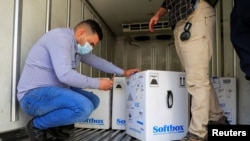 Personnel check the first shipment of the Pfizer's vaccine against the coronavirus disease (COVID-19) at Baghdad International Airport, in Baghdad, Iraq, Apr. 11, 2021. 