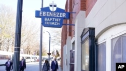 President Joe Biden and Vice President Kamala Harris walk as they arrive for a visit to Ebenezer Baptist Church, Tuesday, Jan. 11, 2022, in Atlanta. 