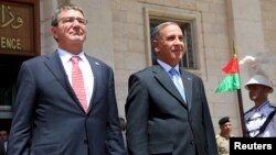 Iraq's Defense Minister Khaled al-Obeidi stands with U.S. Defense Secretary Ash Carter (L) during a welcoming ceremony at the defense ministry in Baghdad July 23, 2015.