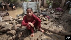 A Pakistani girl in what is left of her house in Nowshera, near Peshawar, Pakistan, Aug. 22, 2012. 