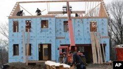 FILE - Work continues on a home in Franklin Park, Pa., Jan. 4, 2019. The Labor Department said Jan. 16, 2020, that it will begin curbing journalists' use of economic data by barring computers from rooms where they receive data before its public release. 