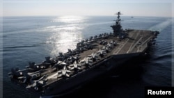 The Nimitz-class aircraft carrier USS John C. Stennis (CVN 74) transits the Strait of Hormuz, in this November 12, 2011 file photo.