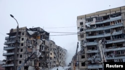 FILE: Emergency personnel work at the site where an apartment block was heavily damaged by a Russian missile strike, amid Russia's attack on Ukraine, in Dnipro, Ukraine. Taken January 15, 2023.